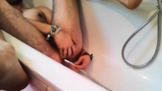 Bi-guy using shower head, squirting water, enema