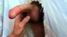 Filling the cocksucker's mouth at the homemade glory hole